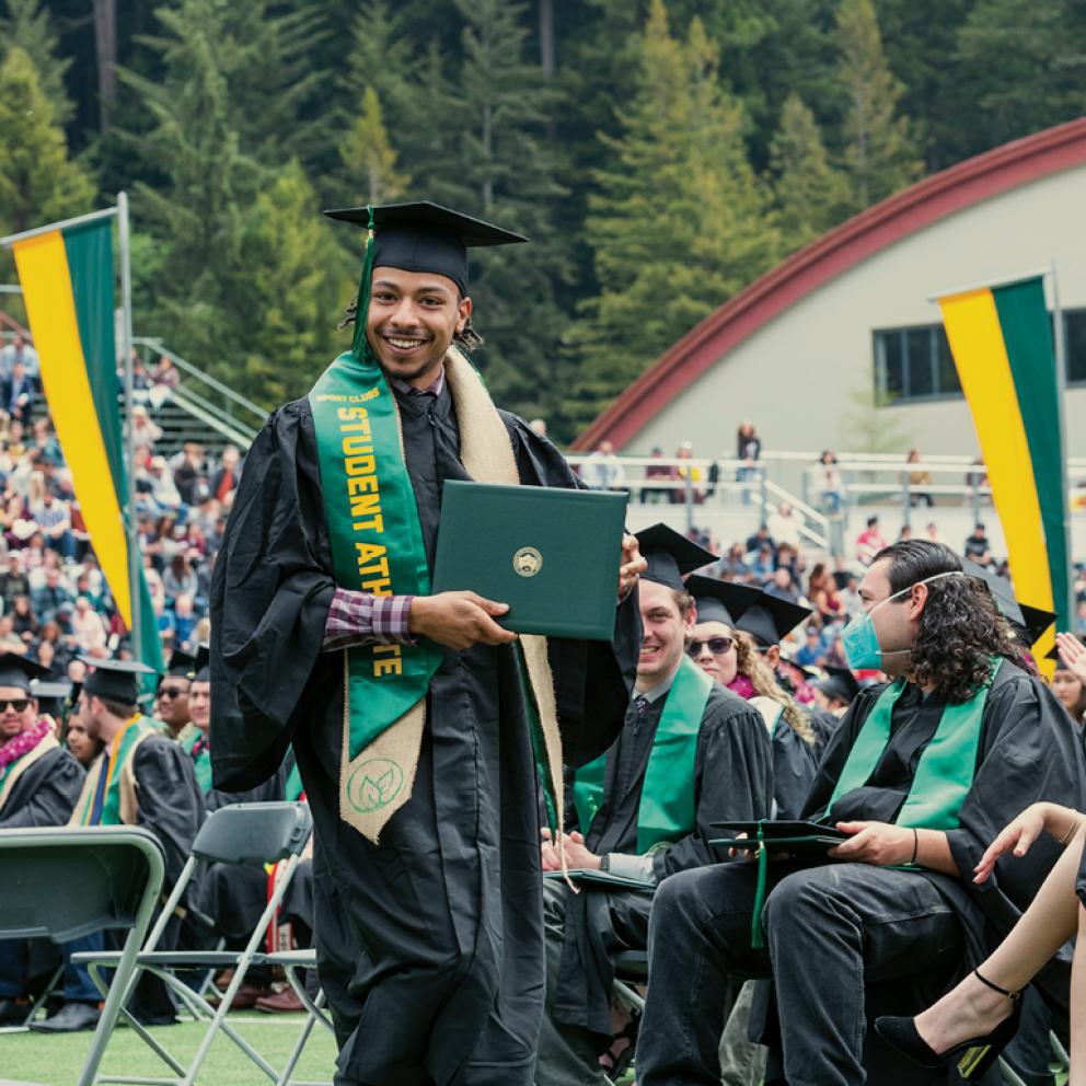 Student at graduation with diploma