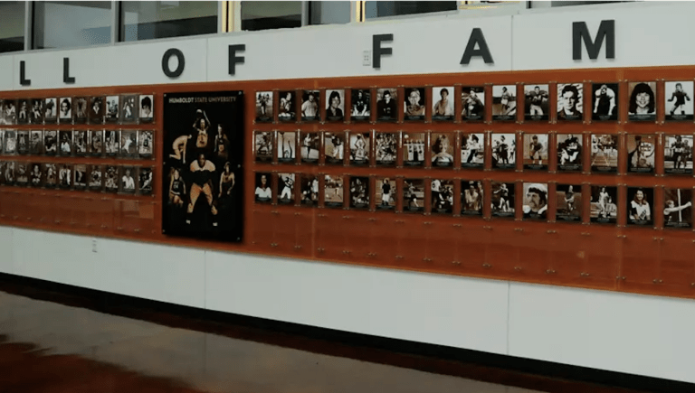 A long view of the Hall of Fame wall in Athletics with photos of all of the winners.