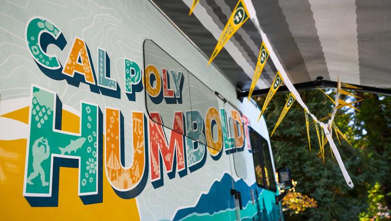 The side view of the Cal Poly Humboldt logo on the Alumni Mobile Center.