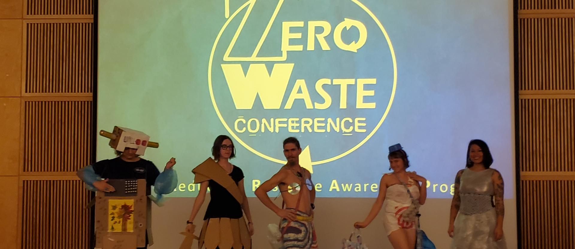 Photo of Trashion Fashion participants in front of screen for the annual Zero Waste Conference