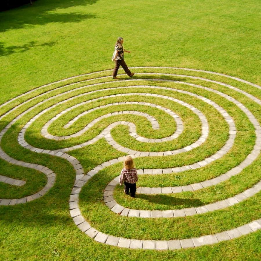 Woman and child walking on a labrynth Woman and child walking on a labrynth