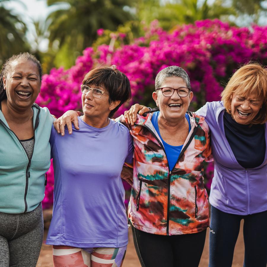 Four women friends laughing together Four women friends laughing together