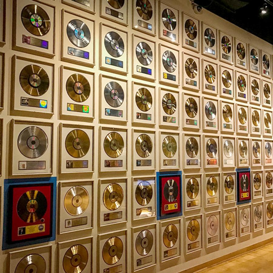 wall of framed gold and platinum records inside the Country Music Hall of Fame and Museum wall of framed gold and platinum records inside the Country Music Hall of Fame and Museum
