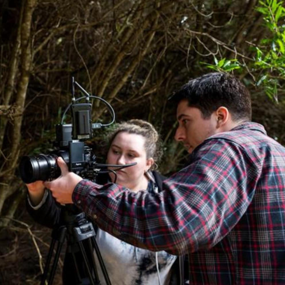 student and professor in the field taking photos