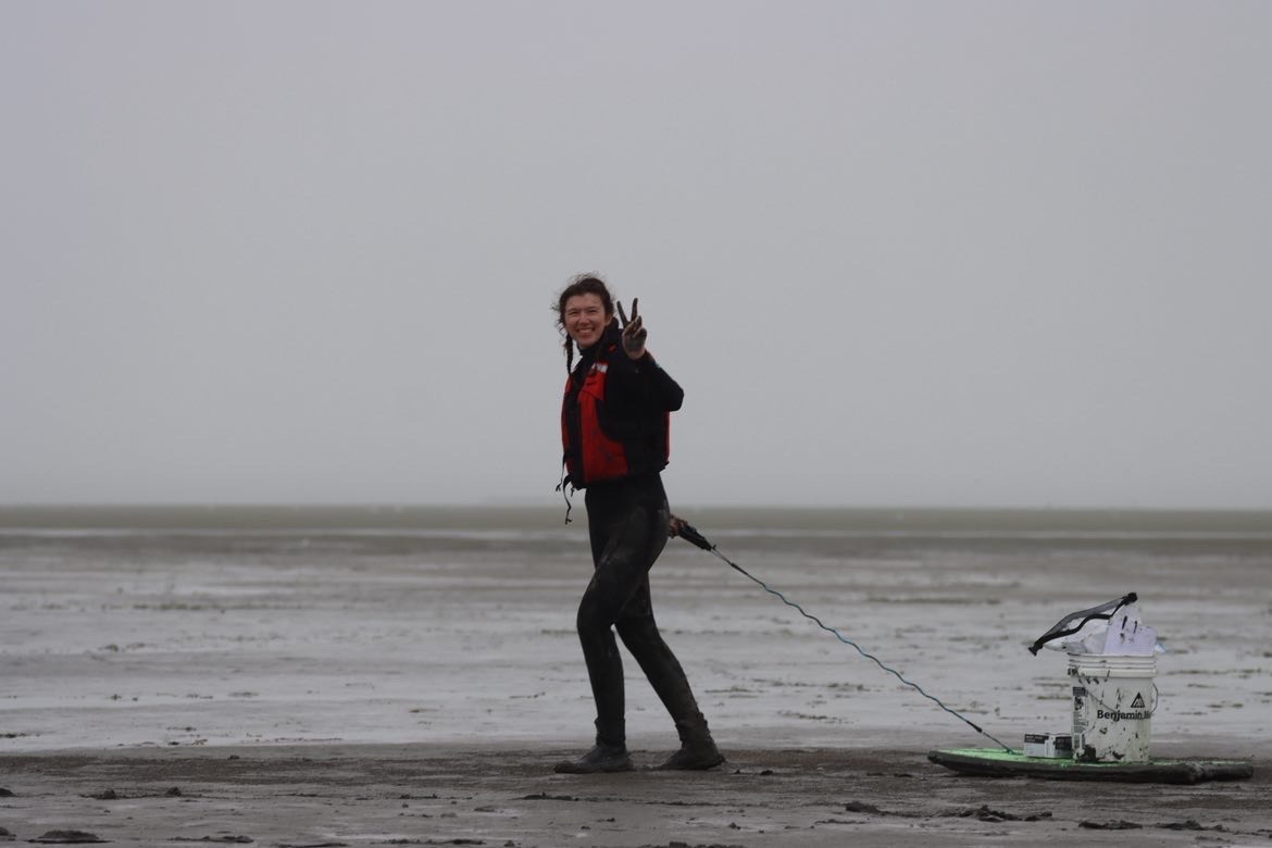 Person on beach in wet suit