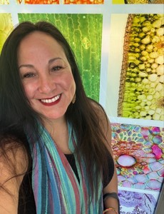 Woman smiling with long brown hair.