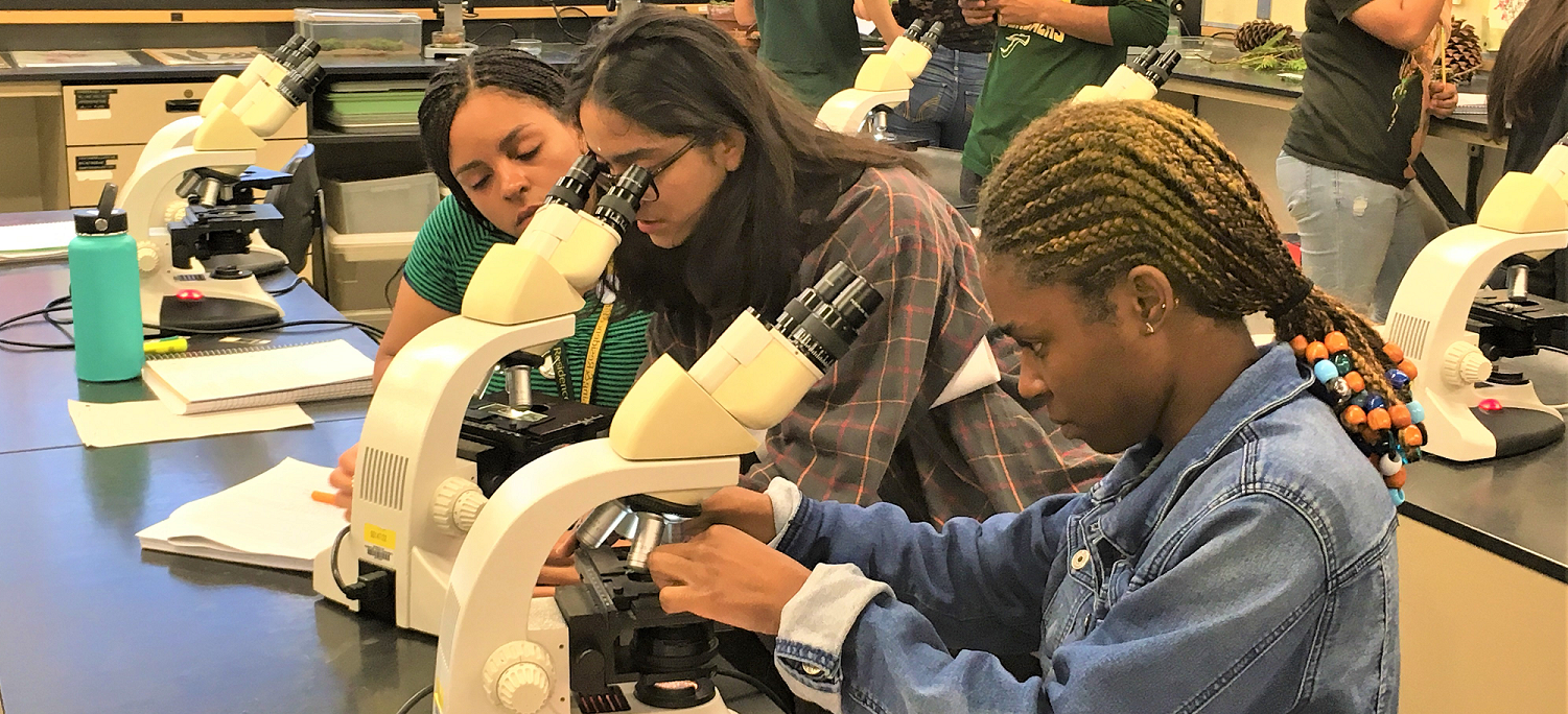 Three students work in science lab