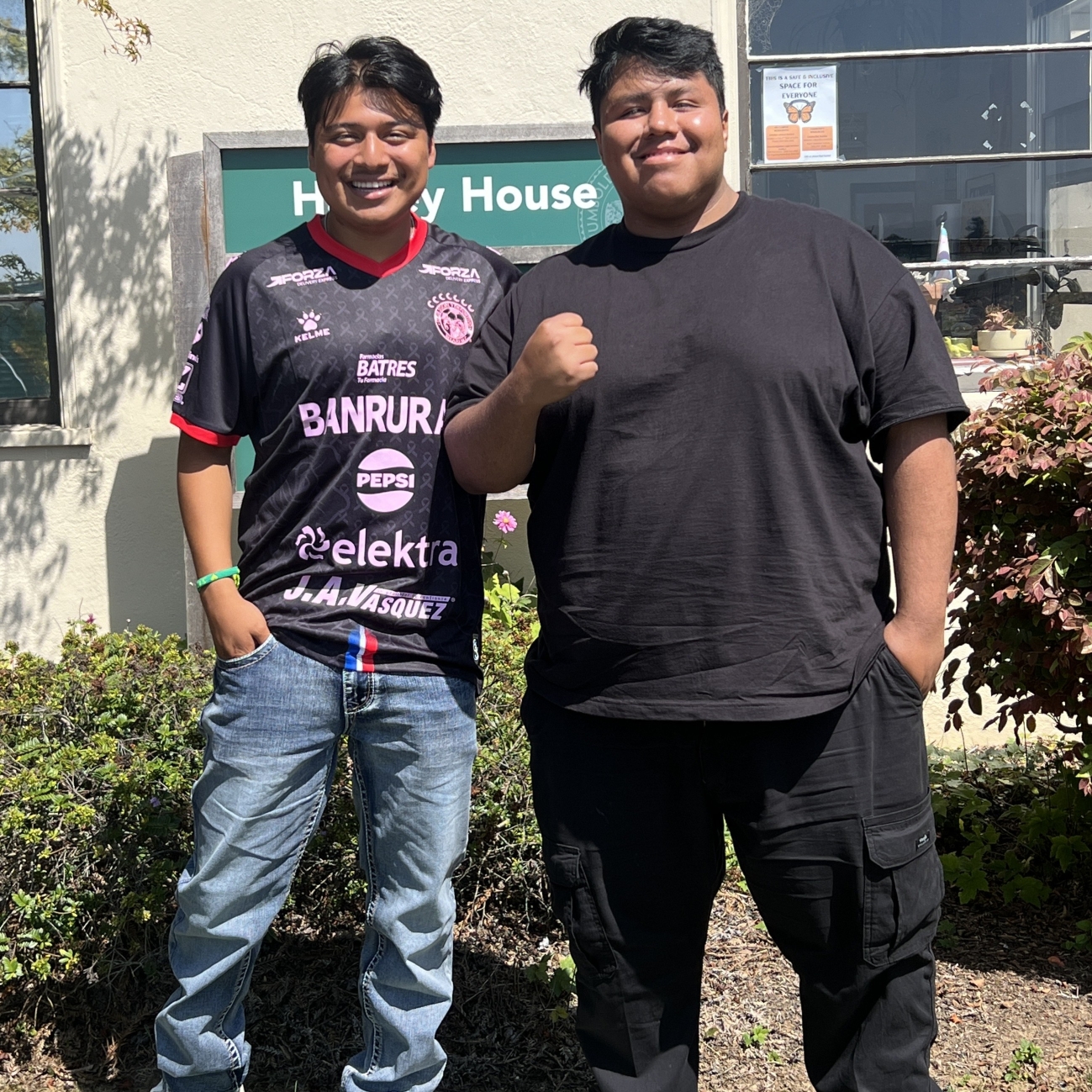 Two men standing by EOP sign