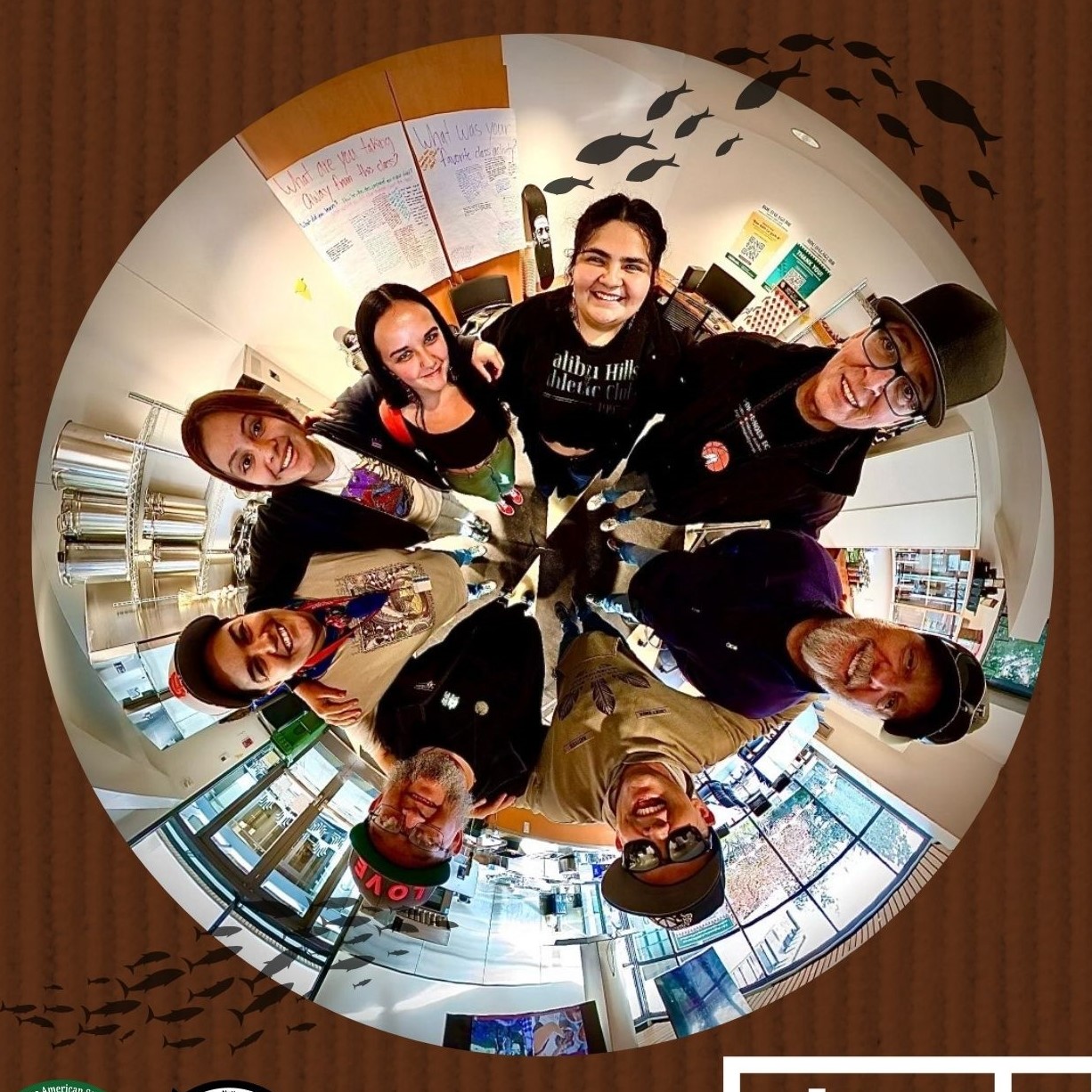 Fisheye lens photo of 8 individuals in a circle inside of the FSL.