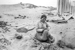 black and white photo of Sally Tom weaving a basket