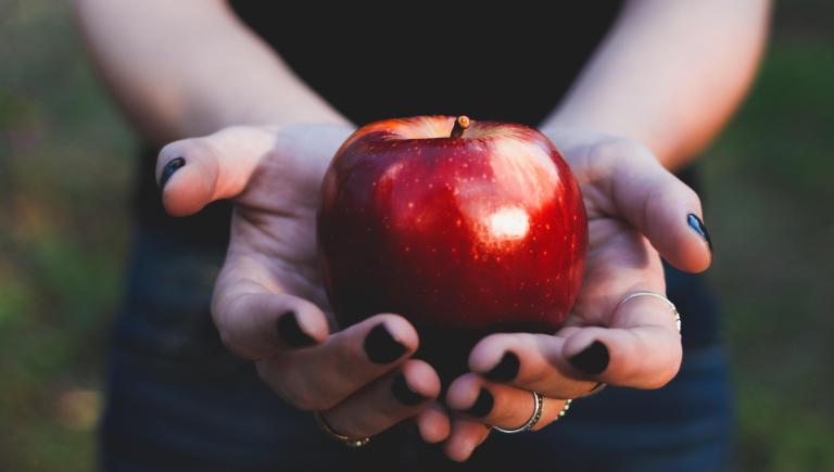 hands holding apple