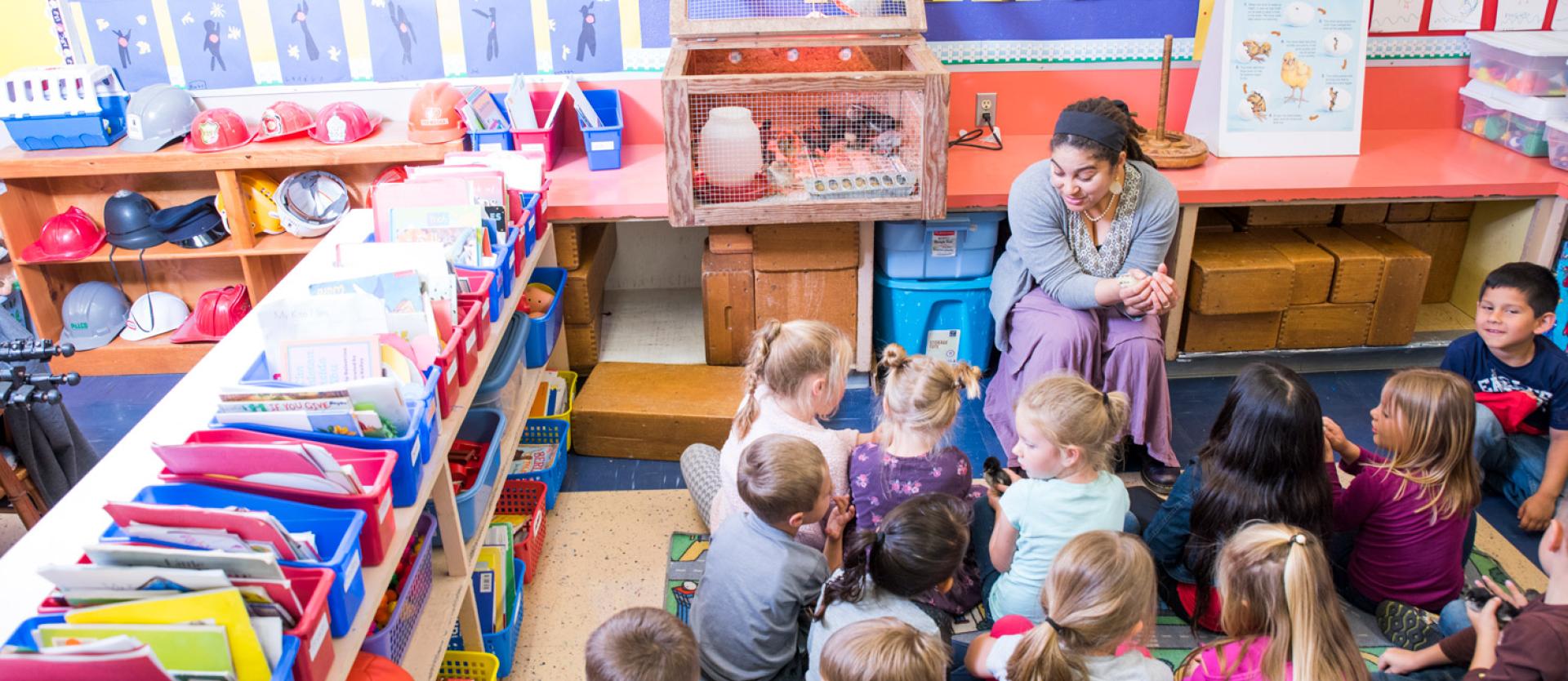 teacher talking to a large group of elementary age students