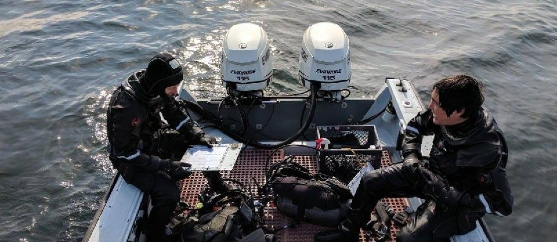 Scuba divers sitting on dive boat