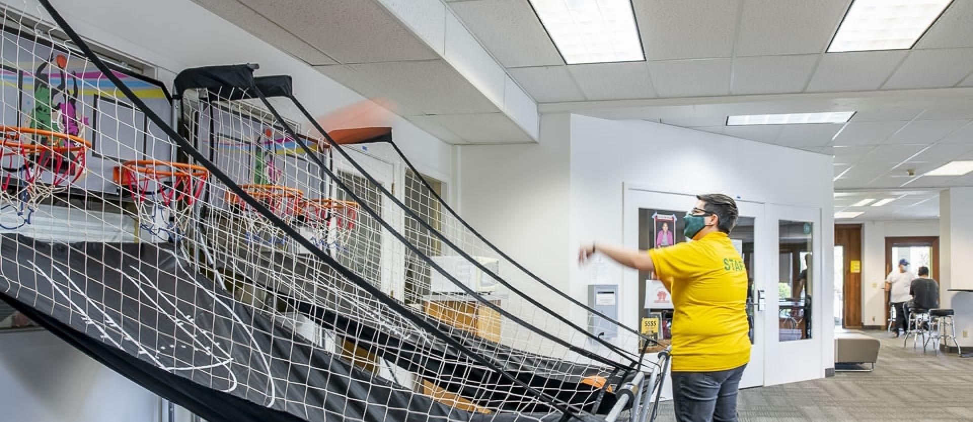 Student Playing basketball arcade game