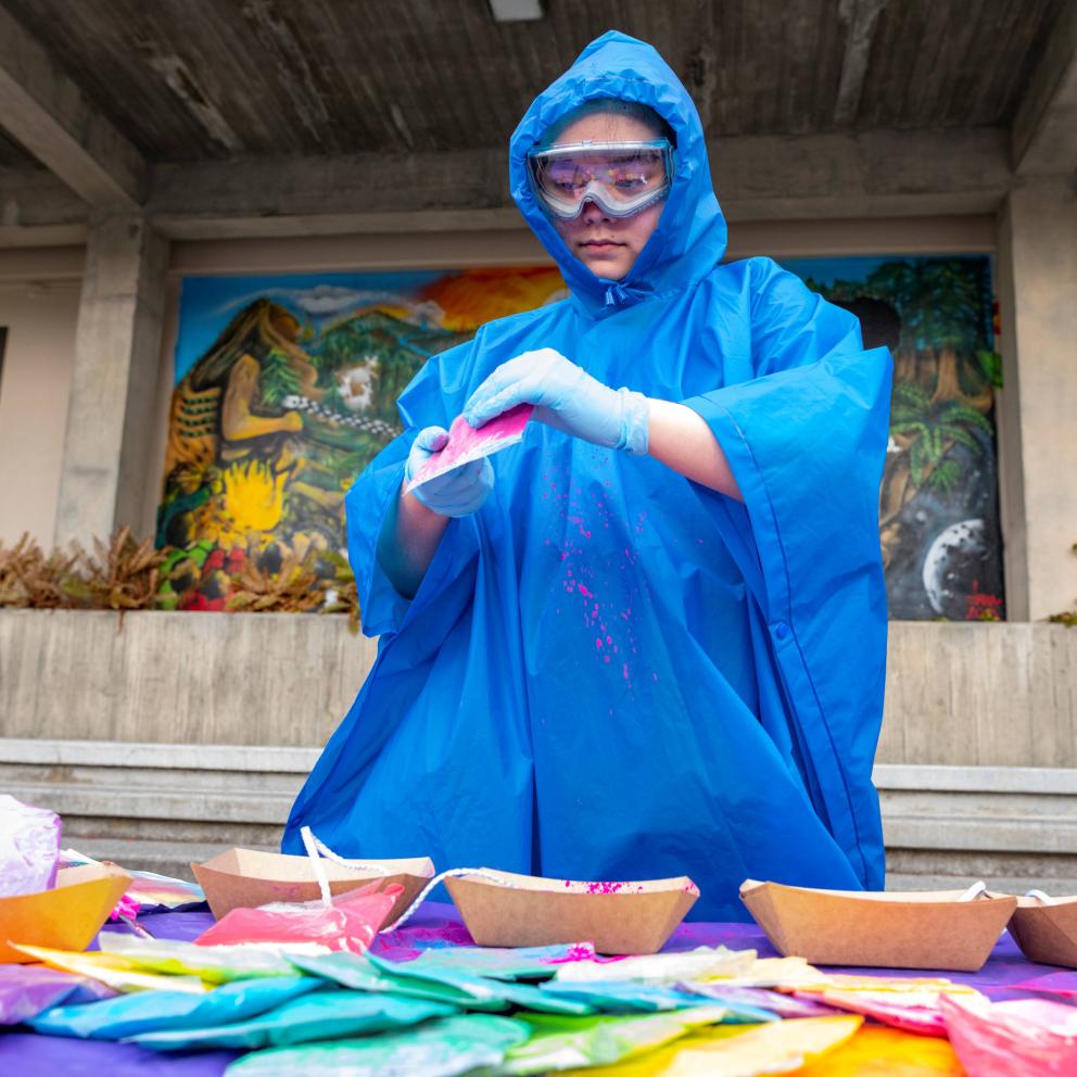 Staff prepares color powder for Holi.