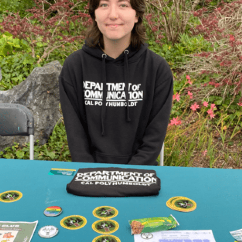 one student at a table wearing a black sweatshirt