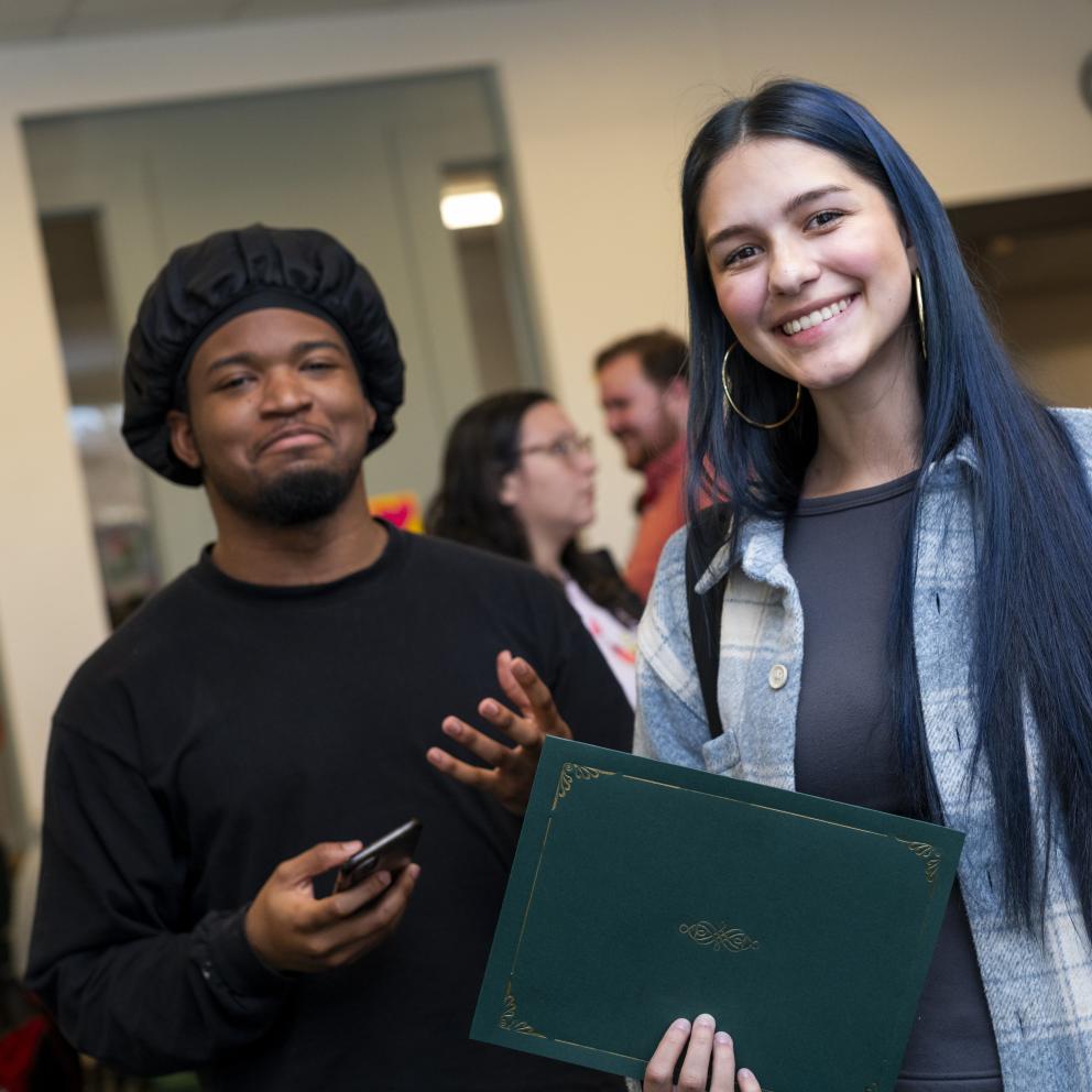 two students with an award