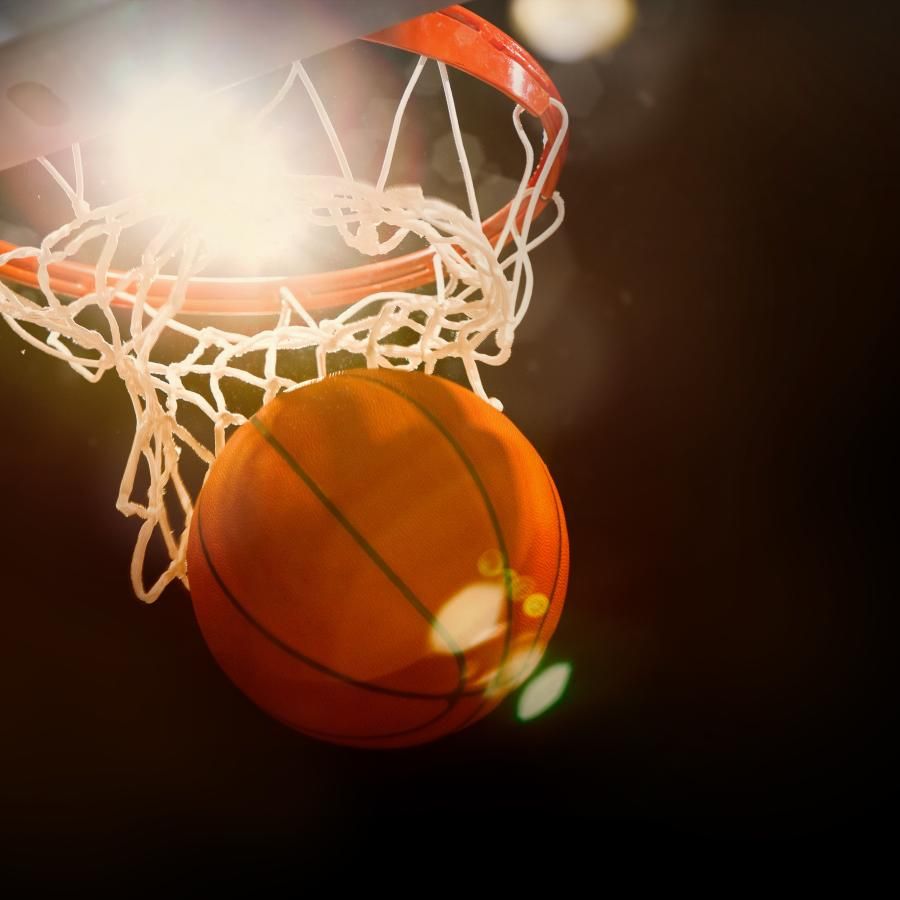 Basketball going through the net of a basketball hoop