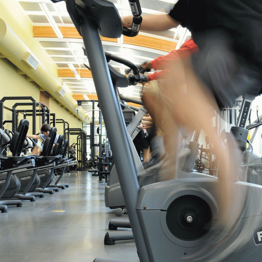 person riding a stationary bike in a gym 