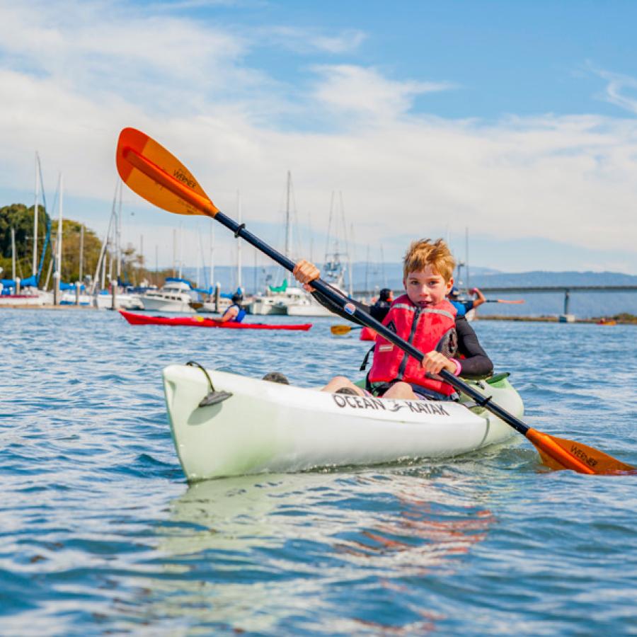 Youth paddling kayak