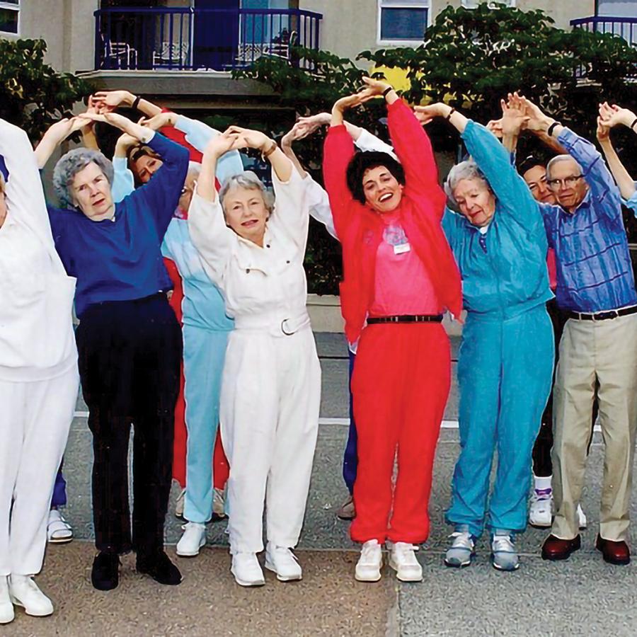 Several people in track suits, doing exercises together