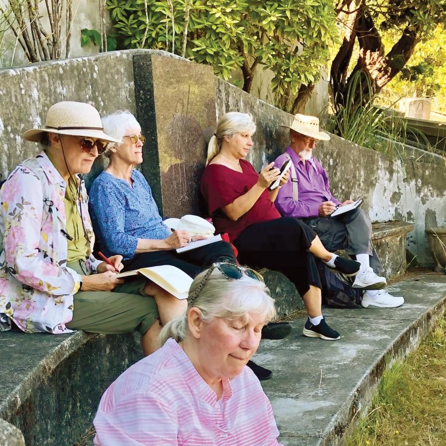 People sitting and sketching in the cemetary in Ferndale