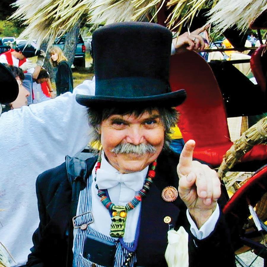 Hobart Brown in a top hat, tuxedo jacket and overalls