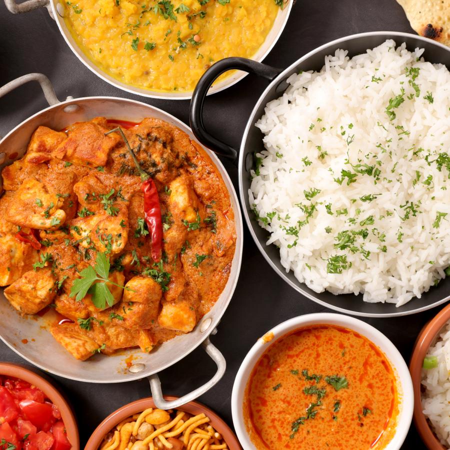 Several pots of a variety of Indian dishes