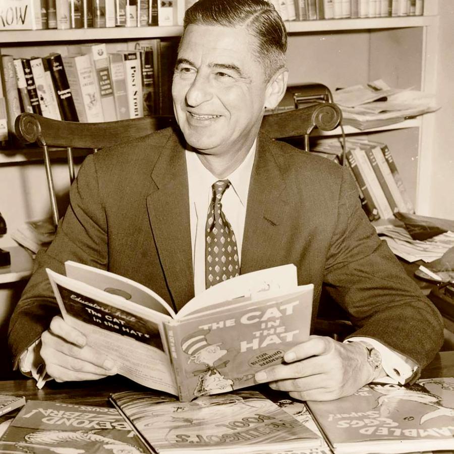 Dr. Seuss holding his book, The Cat in the Hat