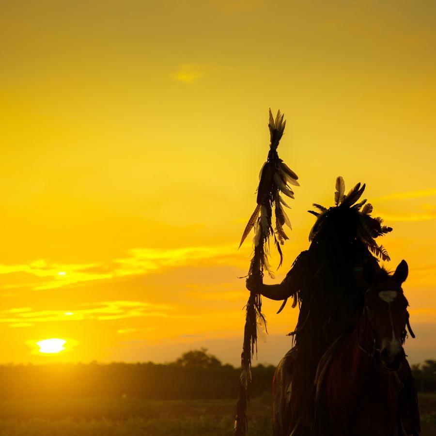 Silhouette of Native American in sunset Silhouette of Native American in sunset