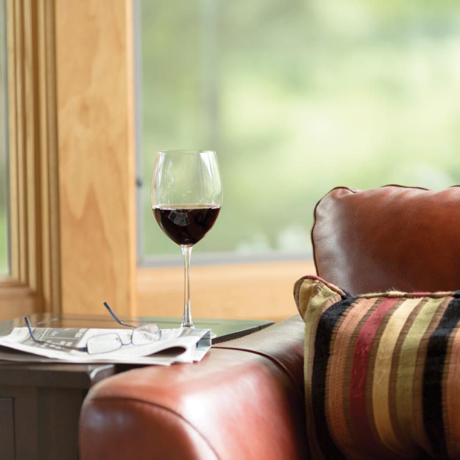 Wine glass on end table next to couch Wine glass on end table next to couch