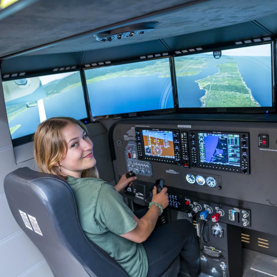 student demonstrating the library's flight simulator student demonstrating the library's flight simulator