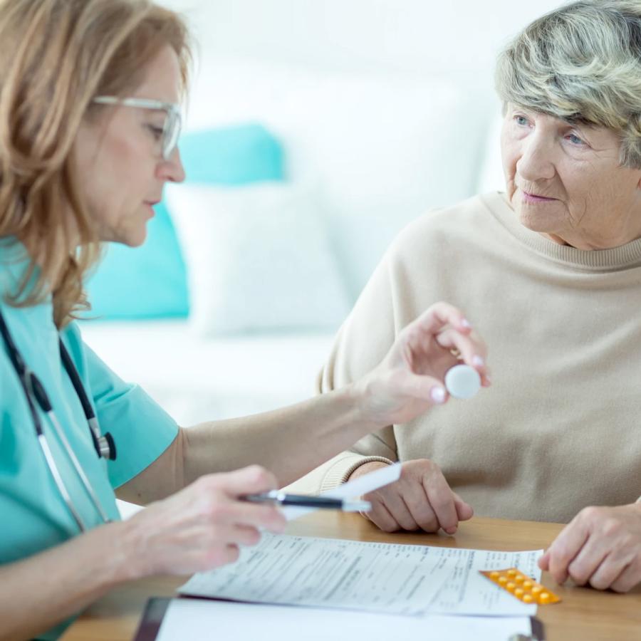 Healthcare practioner talking with older female patient