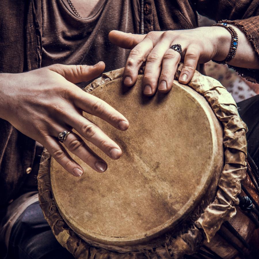 person playing a hand drum person playing a hand drum