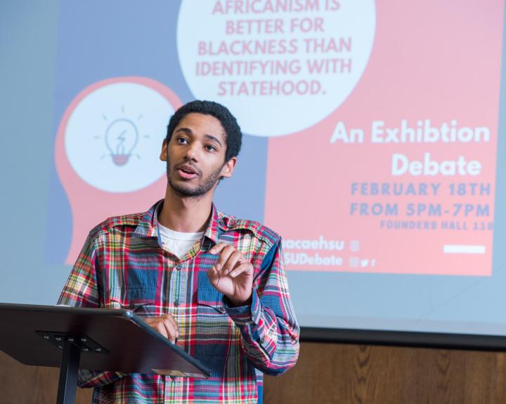 student giving a talk at a podium