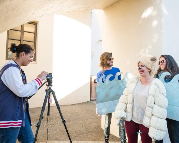 students taking a video dressed as waves