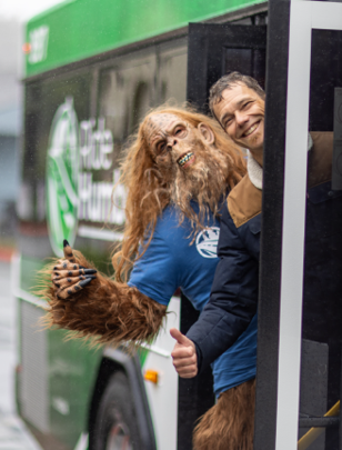 Photo of Bigfoot and a bus rider getting on the bus.